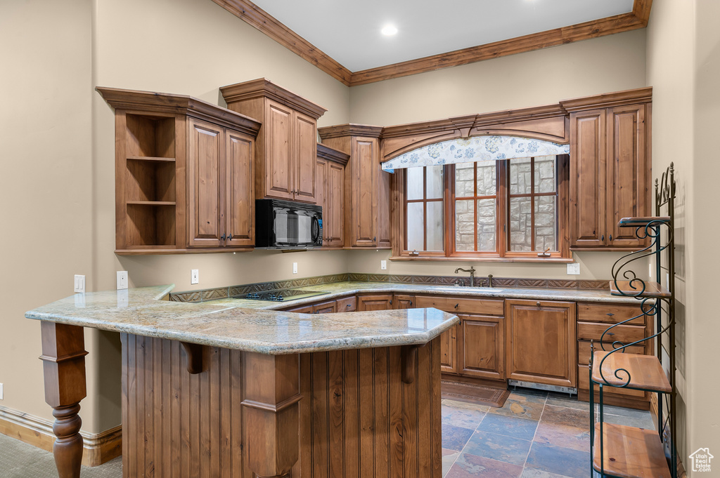 Kitchen featuring black appliances, a peninsula, open shelves, ornamental molding, and a sink