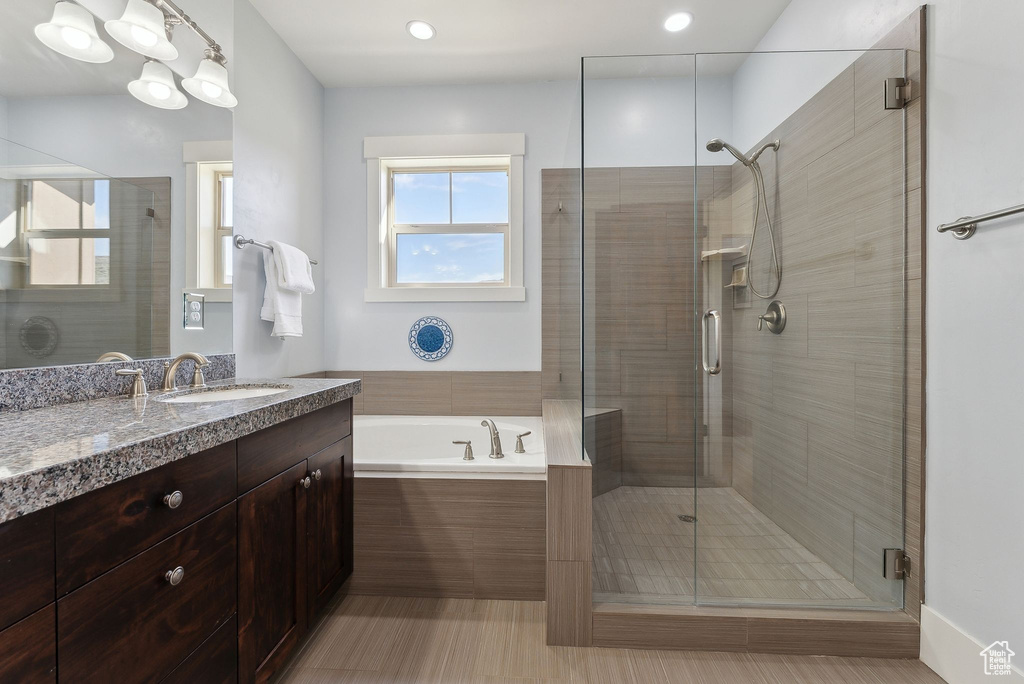 Full bath featuring a shower stall and vanity