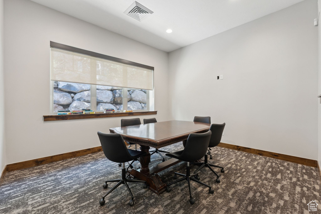 Carpeted office space featuring baseboards and recessed lighting