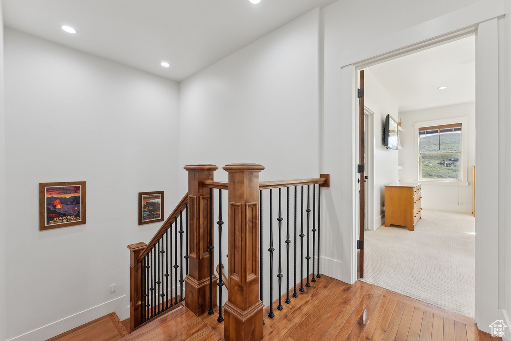 Stairs featuring hardwood / wood-style floors, recessed lighting, and baseboards