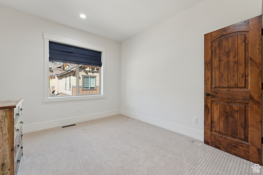 Unfurnished bedroom featuring light colored carpet, baseboards, and recessed lighting