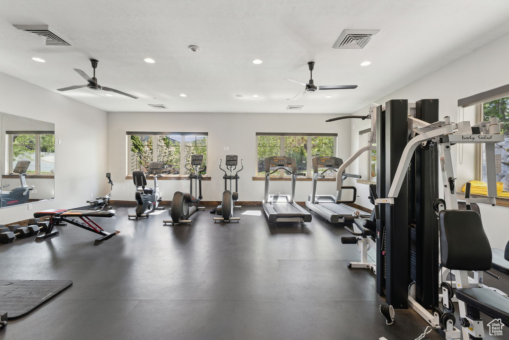 Gym with a ceiling fan, recessed lighting, and baseboards