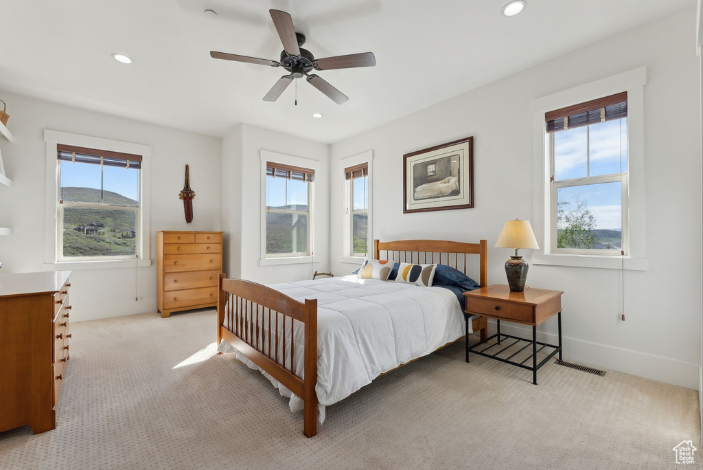Bedroom with light colored carpet, recessed lighting, a ceiling fan, and baseboards