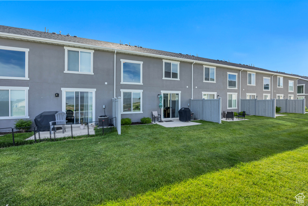 Rear view of house featuring stucco siding and a patio