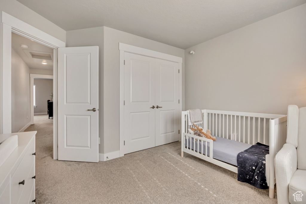 Bedroom with carpet flooring, baseboards, and a closet