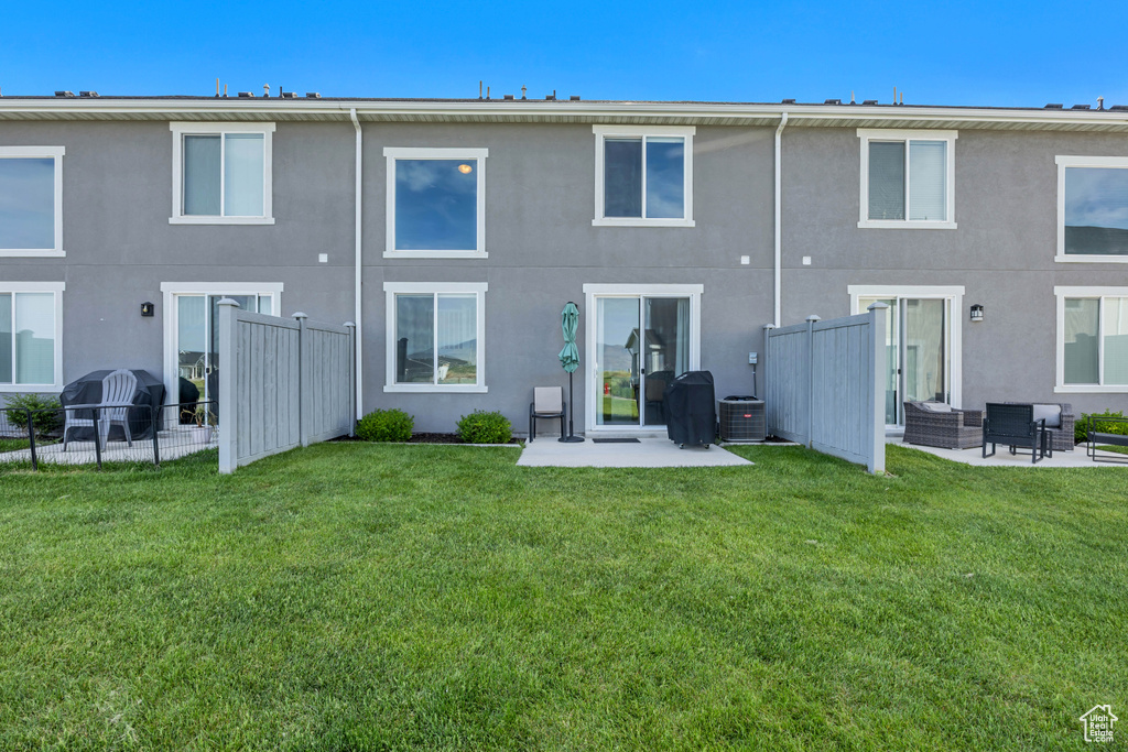 Back of house with stucco siding and a patio