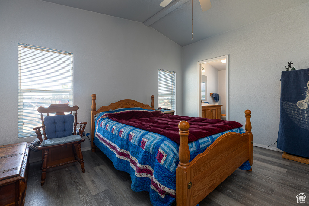 Bedroom with vaulted ceiling, wood finished floors, ensuite bath, and baseboards
