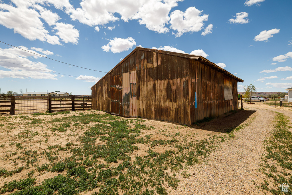 View of pole building with fence