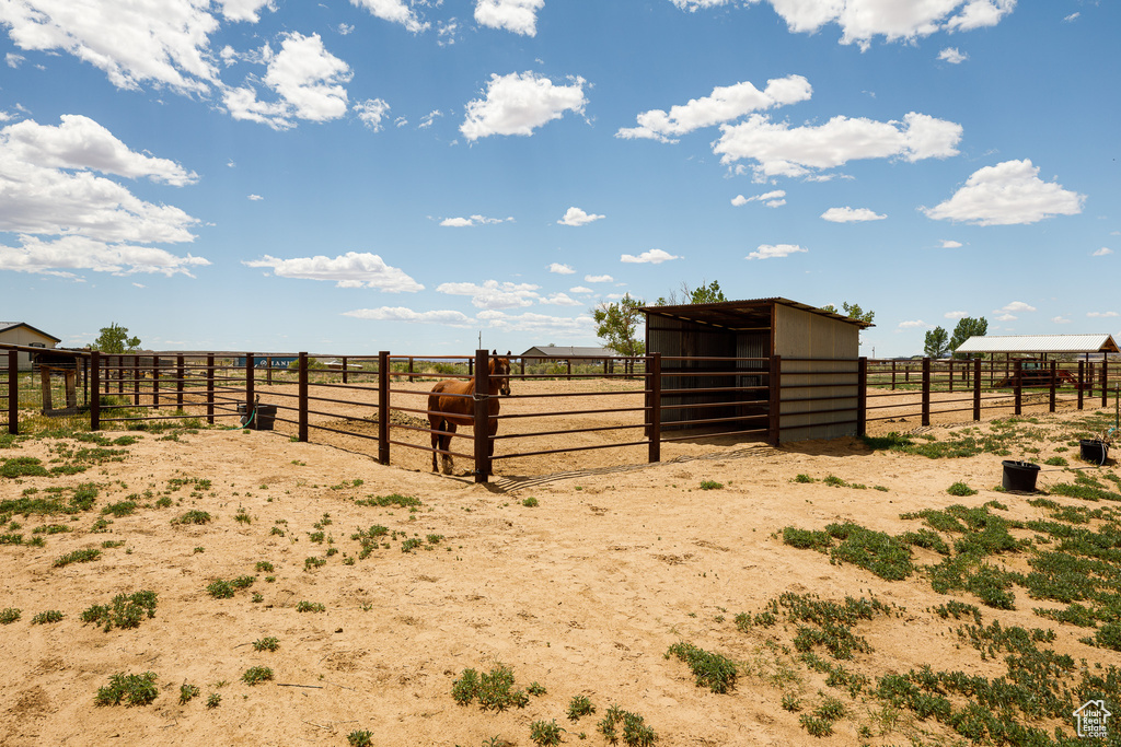 View of yard with an exterior structure, a view of rural / pastoral area, and an outbuilding