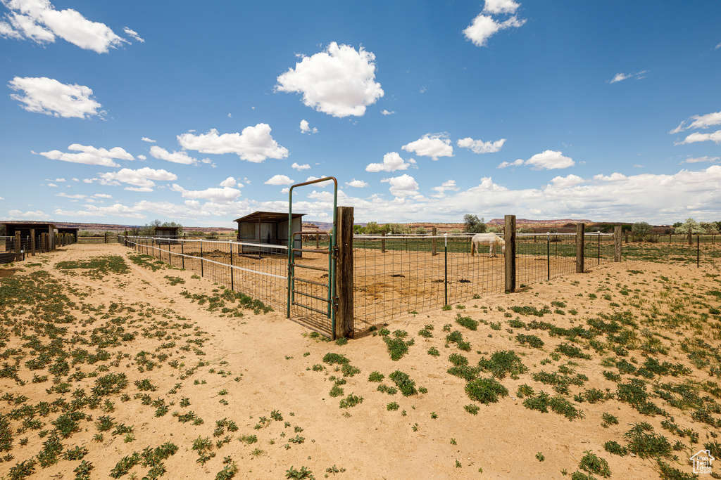 View of yard featuring a view of countryside, an outdoor structure, and an exterior structure