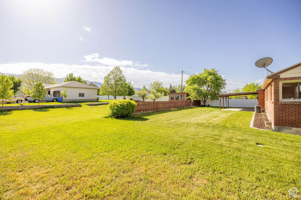 View of yard with an attached carport