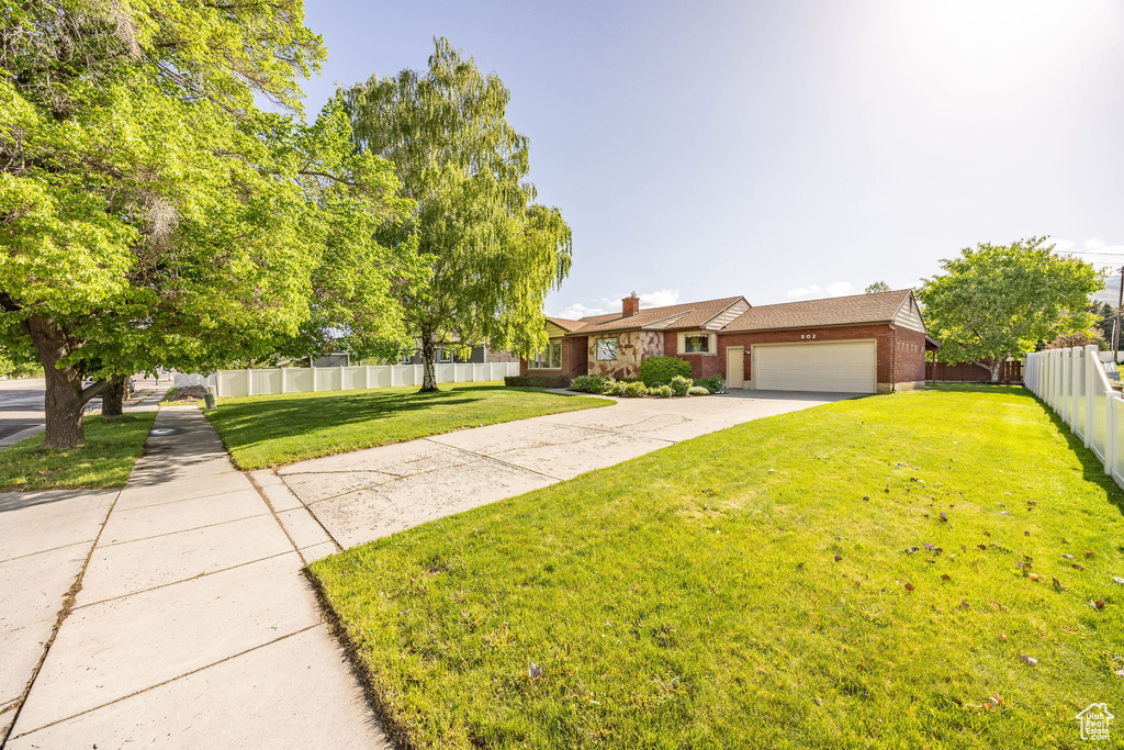 View of front of home featuring brick siding, a garage, and concrete driveway