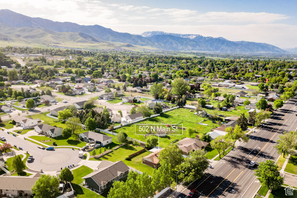Aerial perspective of suburban area featuring a mountain backdrop