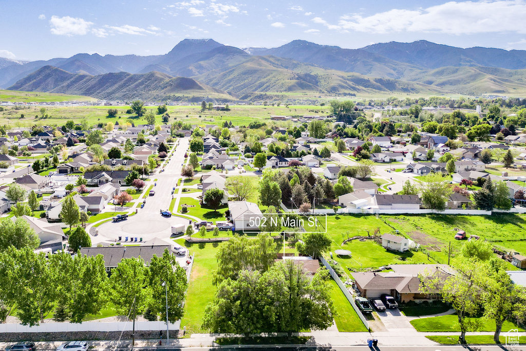 Aerial perspective of suburban area with a mountainous background