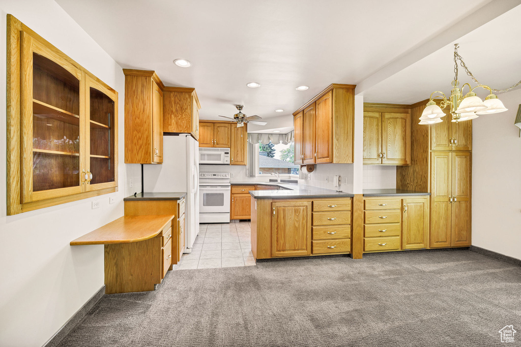 Kitchen with white appliances, light carpet, recessed lighting, brown cabinetry, and baseboards