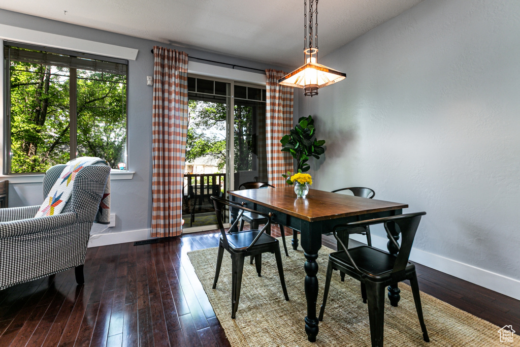 Dining room featuring baseboards and wood-type flooring