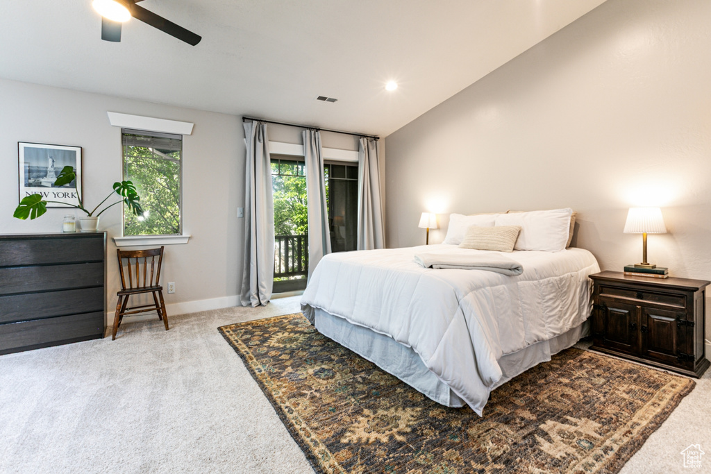 Bedroom with access to exterior, light colored carpet, baseboards, a ceiling fan, and vaulted ceiling