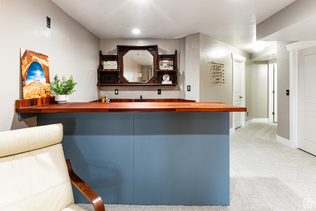 Bar with carpet, baseboards, and recessed lighting