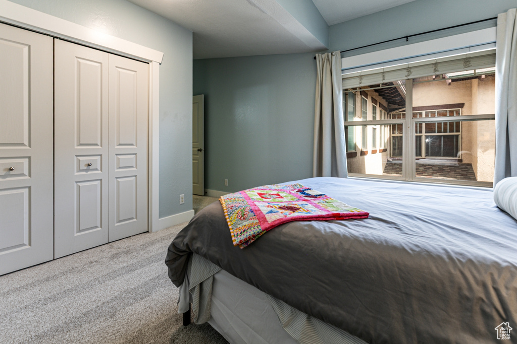 Bedroom featuring carpet, a closet, and baseboards