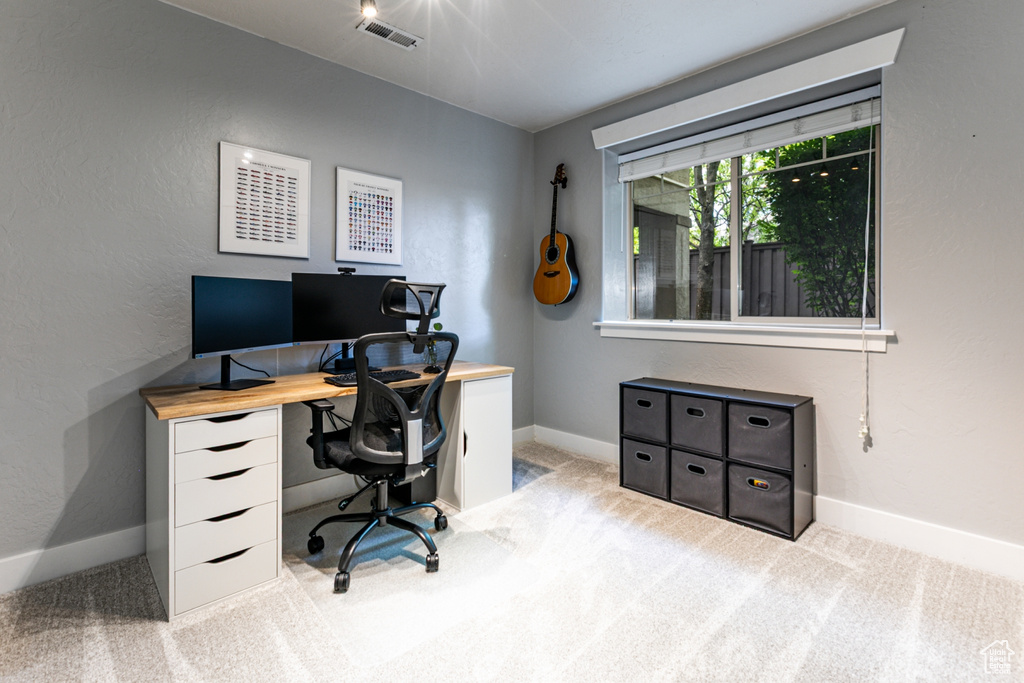Office space featuring light colored carpet and baseboards