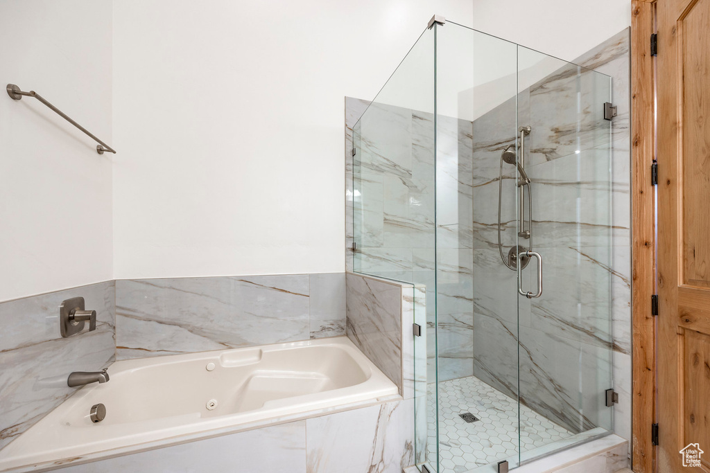 Full bathroom featuring a shower stall and a whirlpool tub
