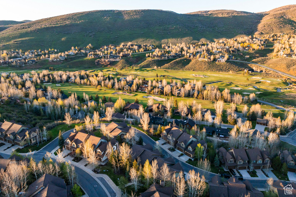 Aerial view of property's location with nearby suburban area and a mountain backdrop