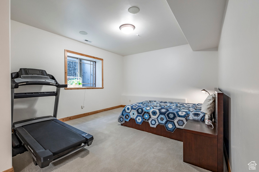 Exercise area featuring carpet and baseboards