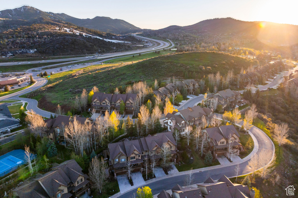 Aerial overview of property\'s location featuring a mountainous background and nearby suburban area