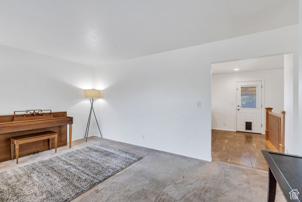 Living area featuring carpet flooring and tile patterned flooring