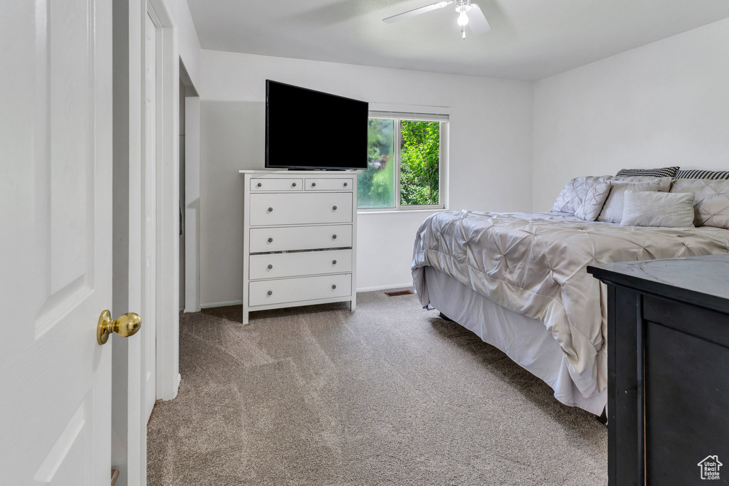 Carpeted bedroom with ceiling fan