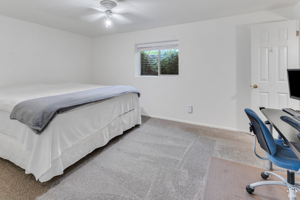 Bedroom with carpet, baseboards, and a ceiling fan