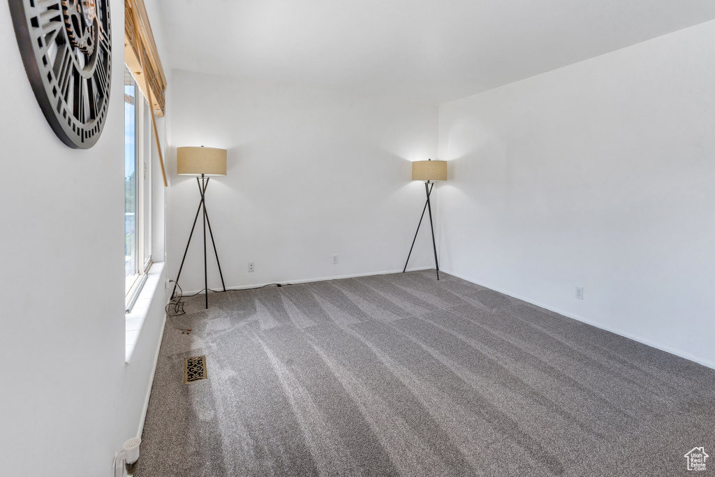 Unfurnished room featuring carpet flooring and baseboards