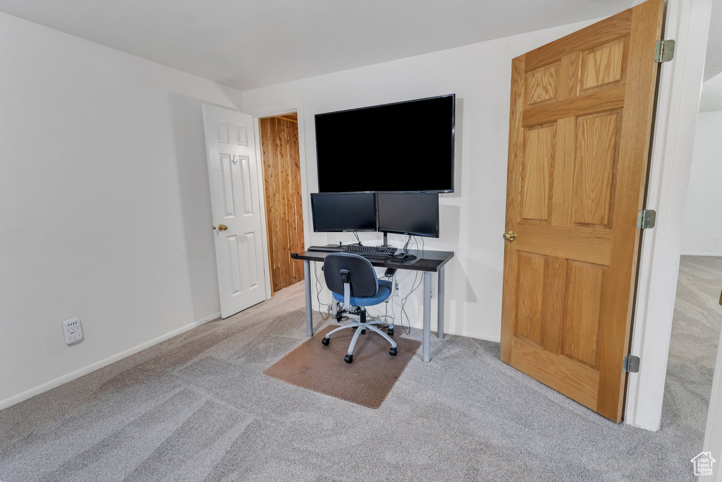 Carpeted office space featuring baseboards