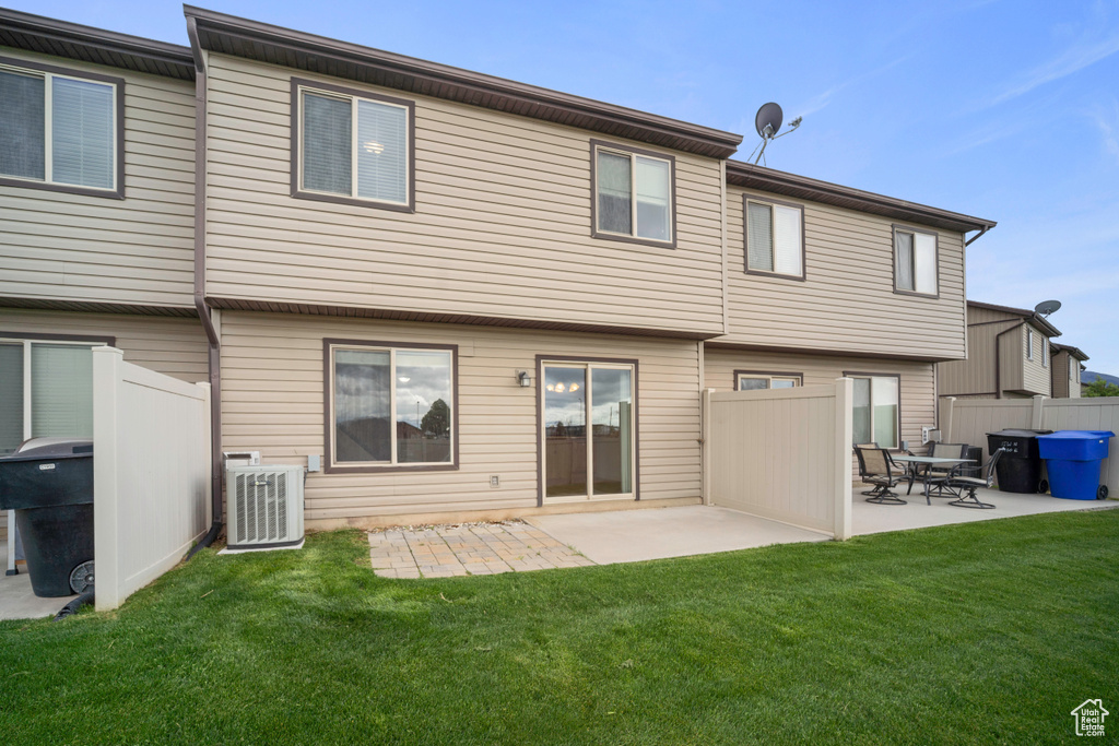 Rear view of property featuring central AC unit and a patio