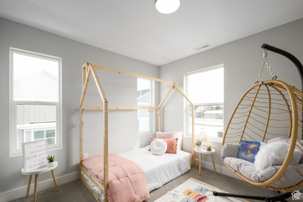 Bedroom featuring carpet floors and baseboards