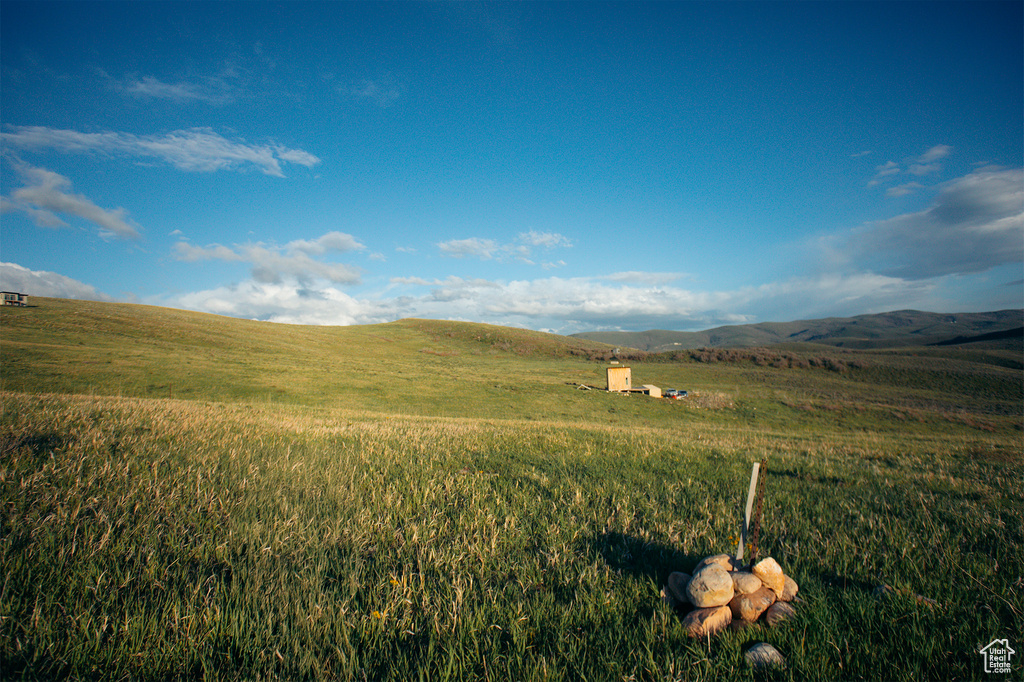 View of mountain backdrop featuring rural landscape