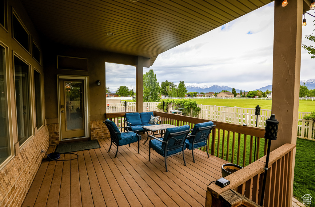 Deck featuring a mountain view and an outdoor living space
