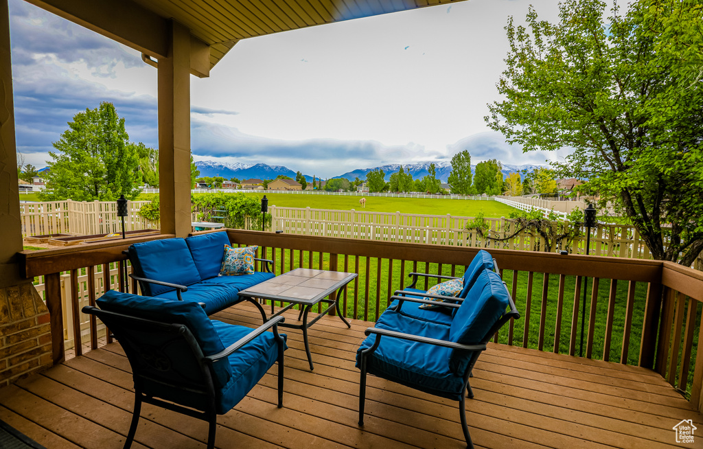 Wooden deck with a mountain view and outdoor lounge area