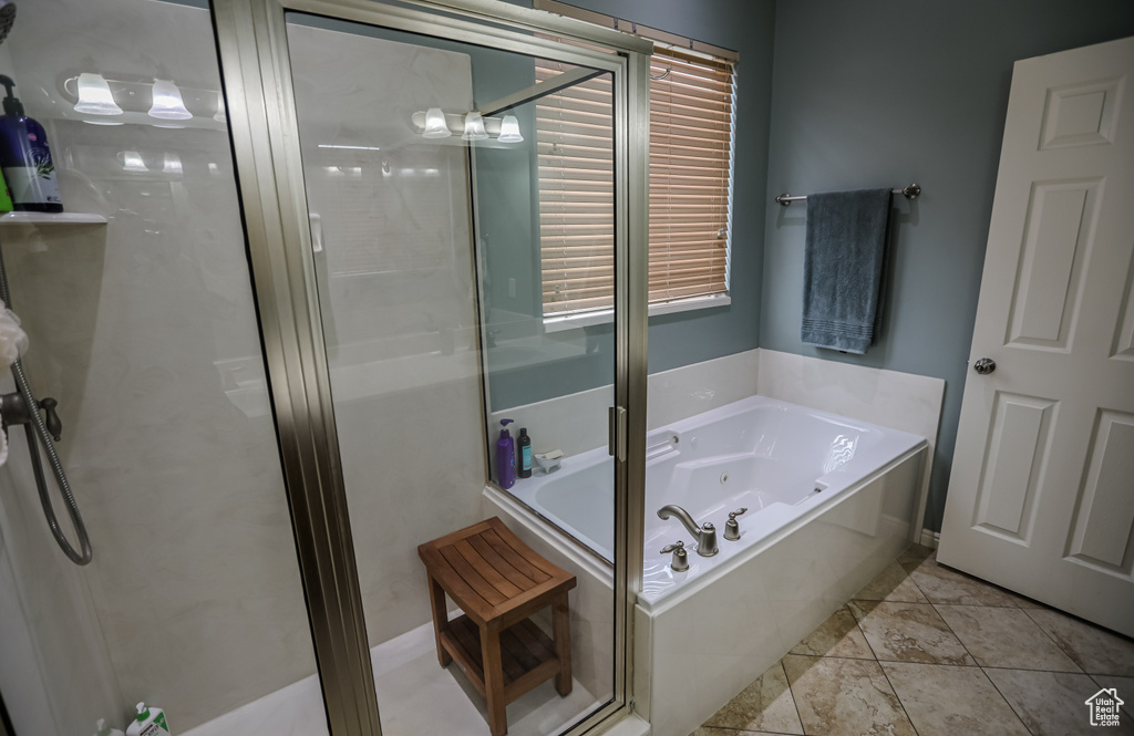 Bathroom featuring a shower stall and a whirlpool tub