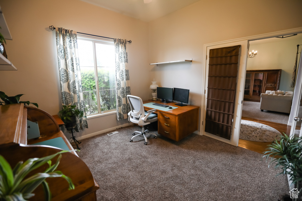 Carpeted office space featuring baseboards