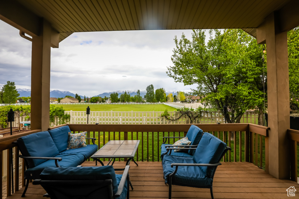 Deck with a mountain view and an outdoor living space