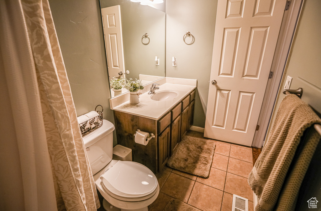 Full bath featuring toilet, tile patterned floors, and vanity