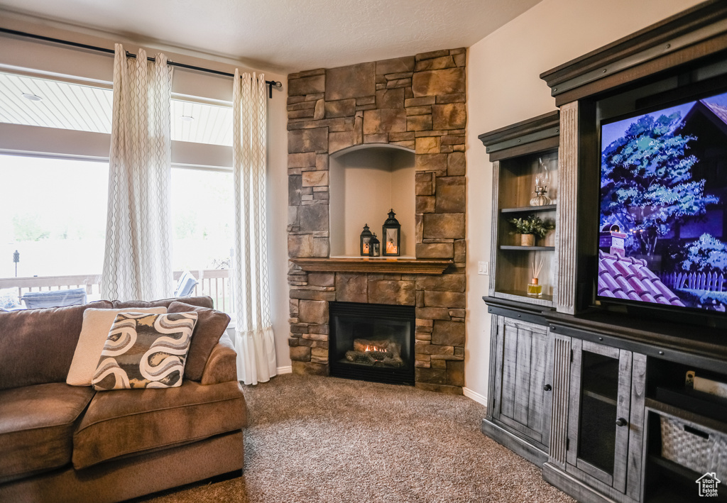 Carpeted living area with a fireplace