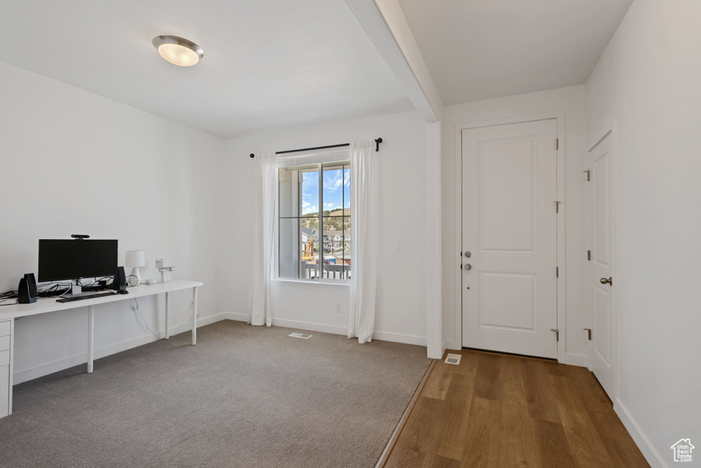 Office with wood finished floors and baseboards