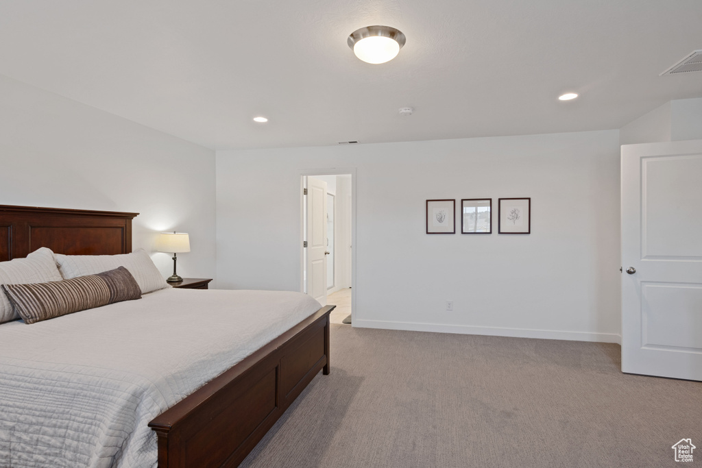 Bedroom featuring light carpet, recessed lighting, and baseboards
