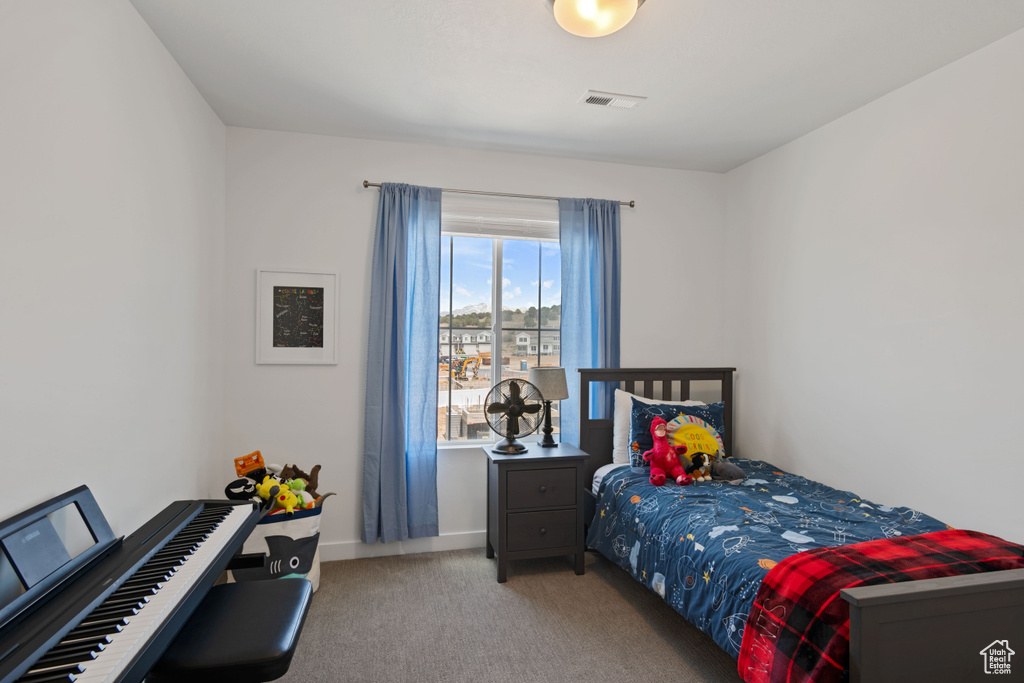 Bedroom featuring carpet floors and baseboards