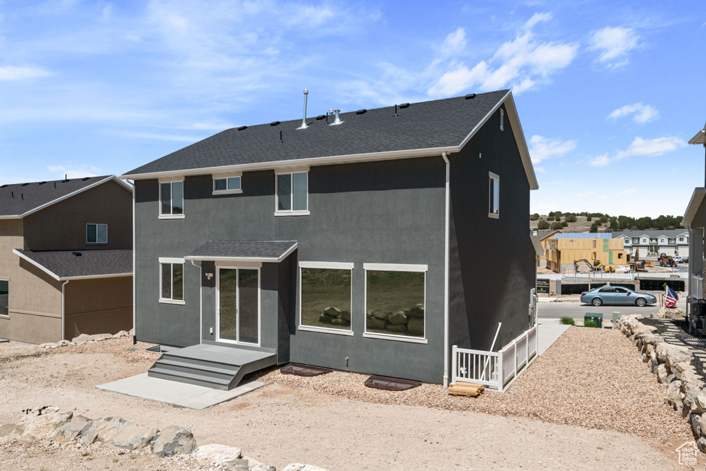 Rear view of property with stucco siding