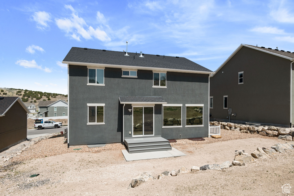 Rear view of property featuring stucco siding