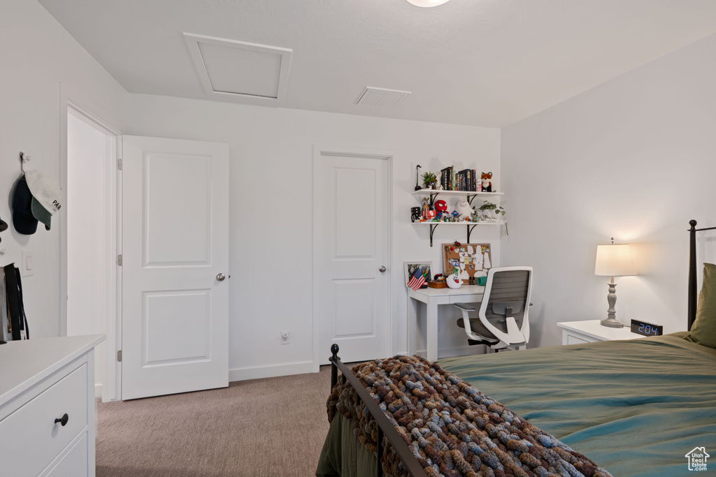 Bedroom featuring light carpet and baseboards