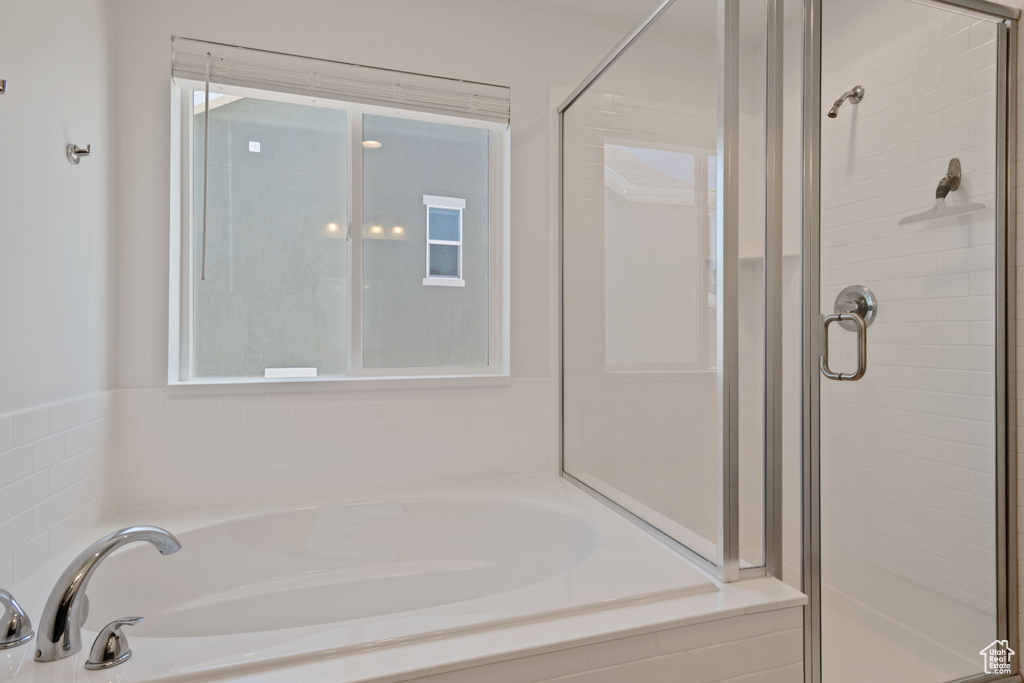 Full bathroom with a stall shower and a garden tub